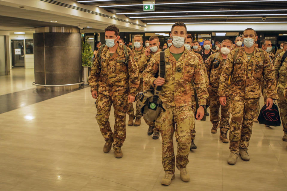 Italian Army soldiers of the last Italian troops withdrawing from Afghanistan walk in the airport in Pisa, Italy, Tuesday, June 29, 2021. The last German and Italian troops returned home from Afghanistan to low-key receptions on Tuesday and Wednesday, June 30, 2021, nearly 20 years after the first soldiers were deployed. Their withdrawal came after many other European allies pulled out their troops without much ceremony in recent days and weeks, bringing the Western mission in Afghanistan close to an end as the United States' own withdrawal looms. (Italian Defense Ministry via AP)