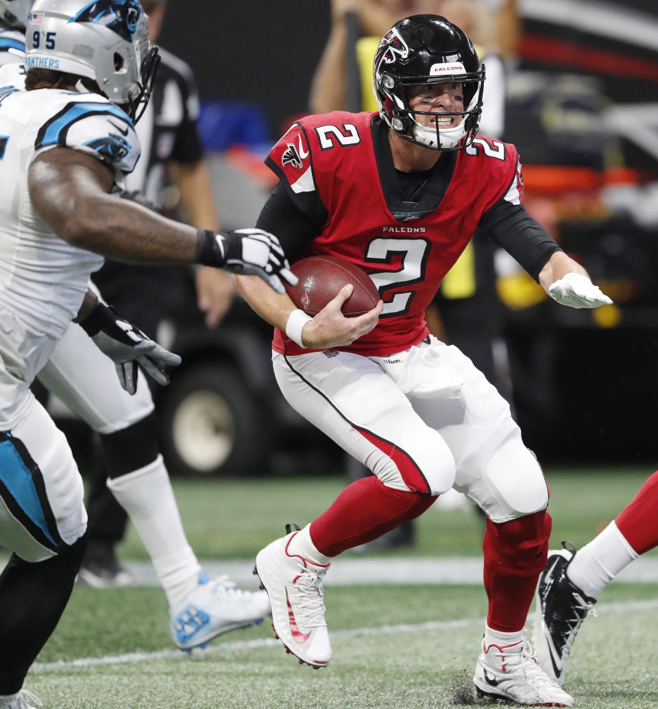 Atlanta Falcons quarterback Matt Ryan (2) runs through Carolina Panthers players during the second half of an NFL football game, Sunday, Sept. 16, 2018, in Atlanta. Ryan scored a touchdown on the play. (AP Photo/John Bazemore)