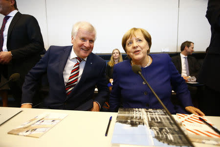 German Chancellor Angela Merkel, leader of the Christian Democratic Union Party (CDU) and Horst Seehofer, head of the CSU and Bavarian premier attend their first parliamentary meeting after the general election in Berlin, Germany September 26, 2017. REUTERS/Fabrizio Bensch