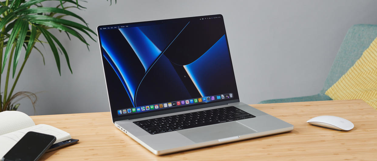  MacBook Pro 16-inch on wooden table in modern office. 