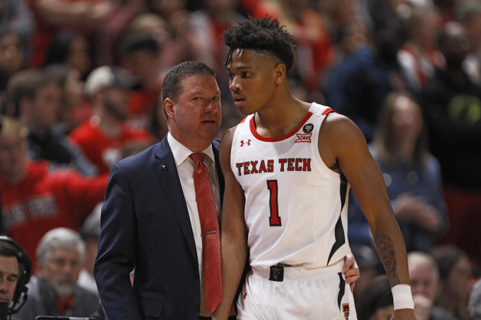 Texas Tech coach Chris Beard, left, talks to Terrence Shannon Jr. (1) during the first half of an NCAA college basketball game against Iowa State, Saturday, Jan. 18, 2020, in Lubbock, Texas. (AP Photo/Brad Tollefson)