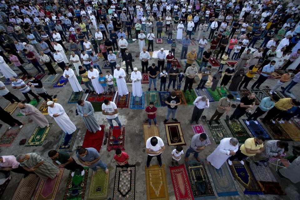 Palestinians Muslims offer Eid al-Adha prayers, in the West Bank city of Nablus, Friday, July 31, 2020. Muslims worldwide marked the the Eid al-Adha holiday over the past days amid a global pandemic that has impacted nearly every aspect of this year's celebrations. (AP Photo/Majdi Mohammed)