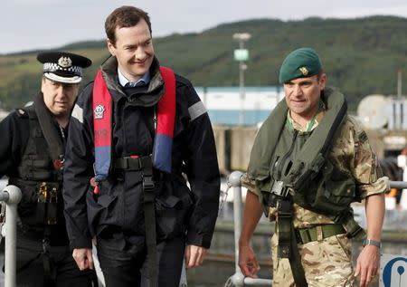 Britain's Chancellor of the Exchequer George Osborne (C) arrives at the jetty of the Royal Navy's submarine base at Faslane, Scotland, August 31, 2015. REUTERS/Russell Cheyne