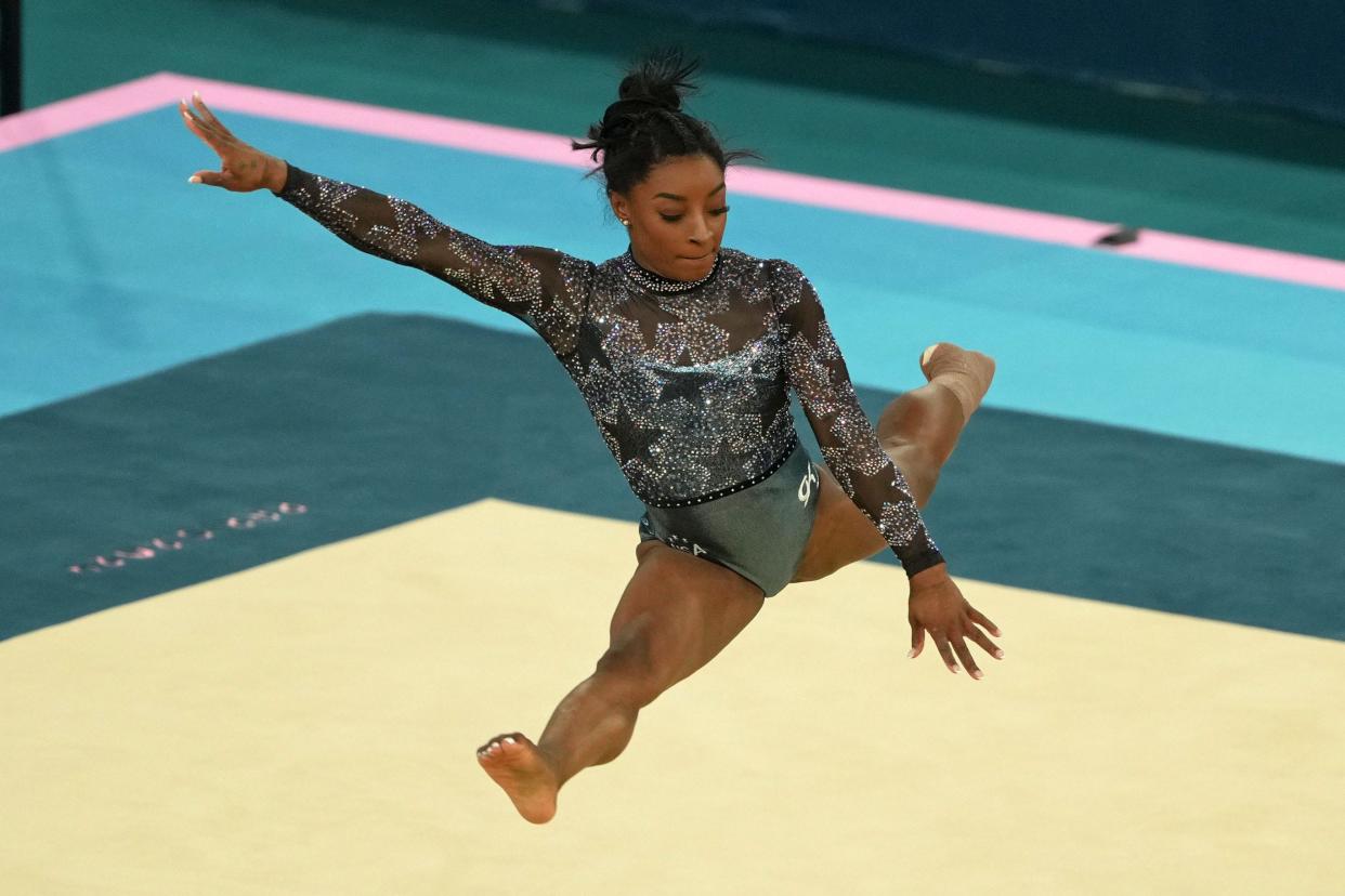 Simone Biles competes on the floor exercise in the women's team qualifying on Sunday.