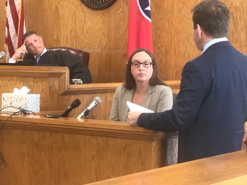 Tennessee Bureau of Investigation Agent Kendra Fleenor, center, answers questions from Alex Little, right, about the fingerprint evidence in the case of Adam Braseel as Judge Justin Angel listens.