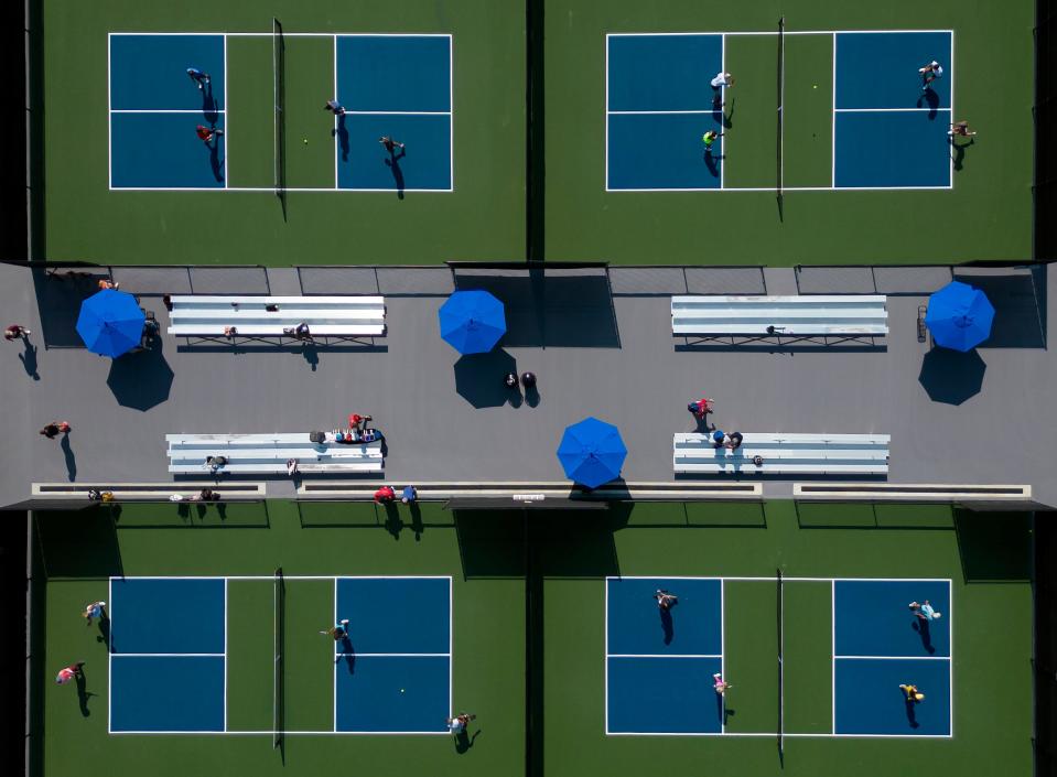 Jul 11, 2023; New Albany, Ohio, USA;  Groups of doubles play pickleball during the grand opening of the New Albany Pickleball Complex in Bevelhymer Park.