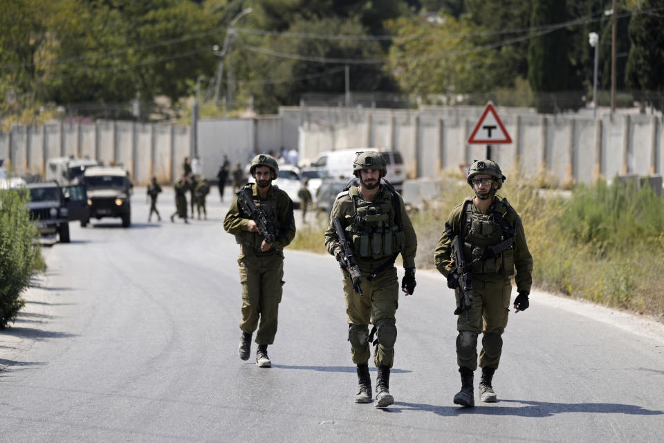 ADDS THAT THE SOLDIER DIED FROM HIS INJURIES - Israeli military forces work near the site where a soldier was killed by gunfire near the West Bank Jewish settlement of Shavei Shomron, Tuesday, Oct. 11, 2022. (AP Photo/Majdi Mohammed)