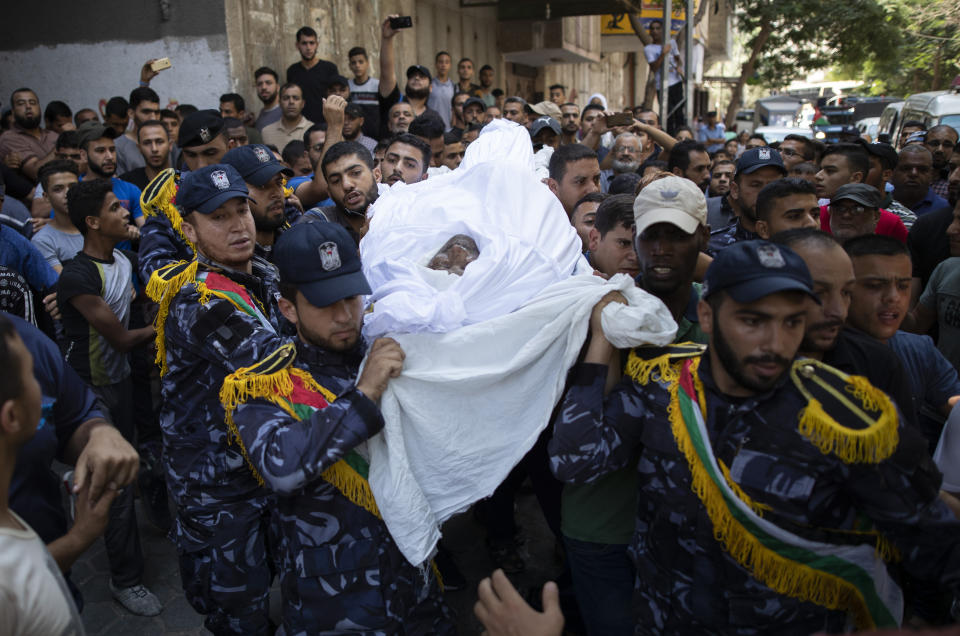 Members of the Hamas police force carry the body of Palestinian Hamas police officer, Wael Khalifa, 45, during his funeral in the Buriej refugee camp, central Gaza Strip, Wednesday, Aug. 28, 2019. Khalifa and two other Hamas police officers were killed in explosions that ripped through police checkpoints in Gaza City overnight, Hamas' interior ministry said. (AP Photo/Khalil Hamra)