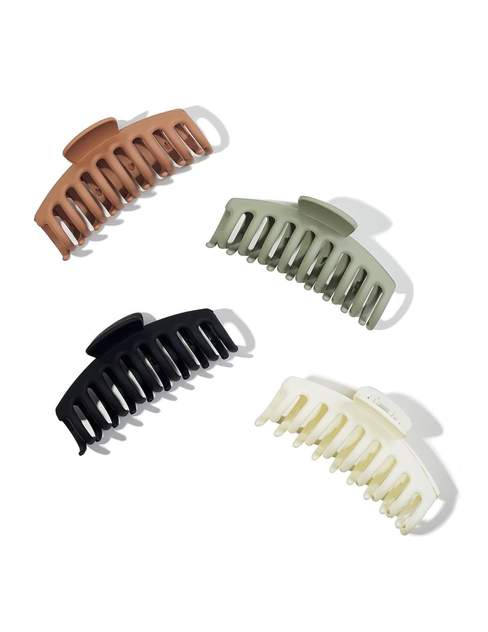 Four claw clips in brown, green, black and cream.