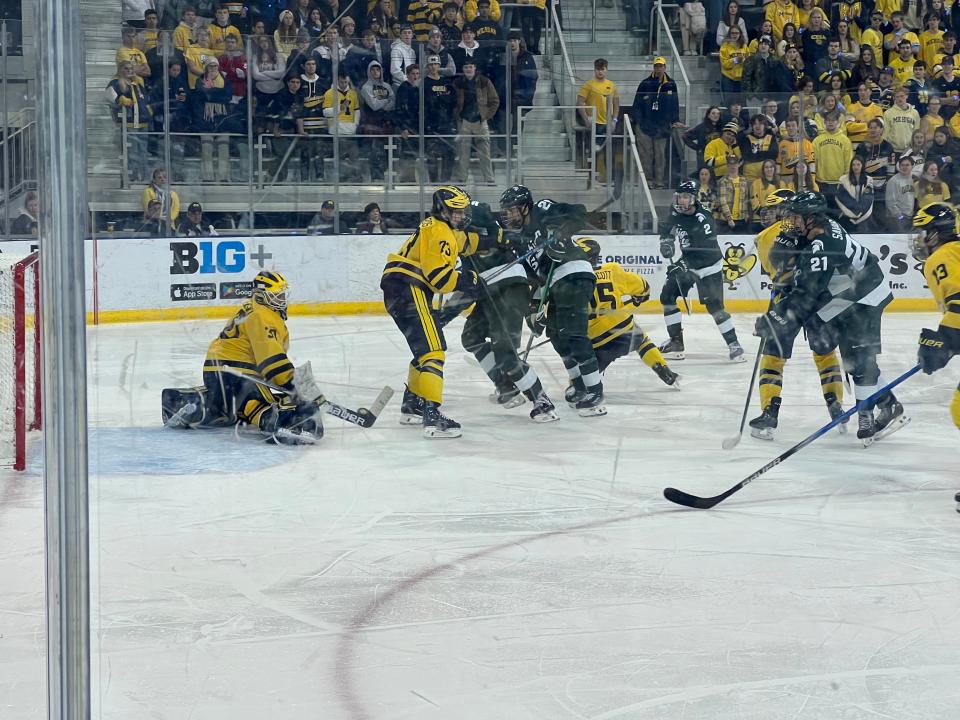 MSU and Michigan battle near Michigan's goal during the third period Saturday night.