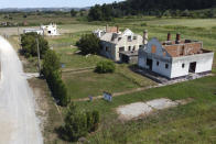 Abandoned and roofless houses bought by Rio Tinto company are seen in the village of Gornje Nedeljice, in the fertile Jadar Valley in western Serbia, Tuesday, Aug. 6, 2024. (AP Photo/Darko Vojinovic)