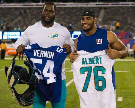 FILE PHOTO: Aug 12, 2016; East Rutherford, NJ, USA; Miami Dolphins offensive tackle Branden Albert (76) and New York Giants defensive end Olivier Vernon (54) after the game f at MetLife Stadium. The Miami Dolphins defeat the New York Giants 27-10. Mandatory Credit: William Hauser-USA TODAY Sports / Reuters Picture Supplied by Action Images/File Photo