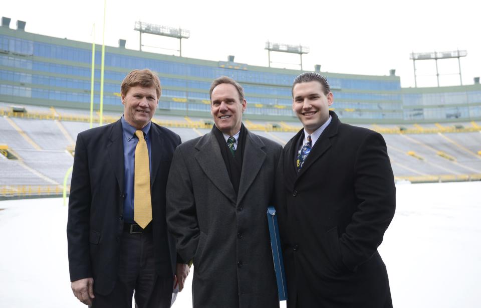 Green Bay Packers President and CEO Mark Murphy stands inside Lambeau Field with Steve Schumer of Gillette, N.J.,  and his son, Adam, after Steve Schumer was named the 17th member of the Green Bay Packers FAN Hall of Fame in 2015.