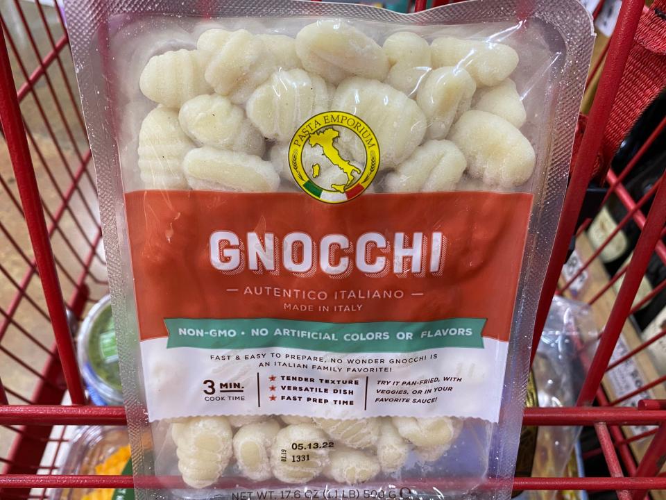 Trader Joe's gnocchi in clear and red packaging in red cart