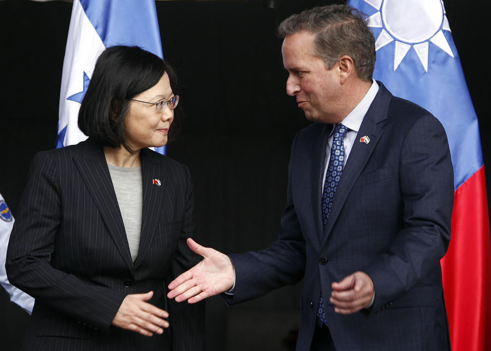 CORRECTS SPELLING OF GUATEMALA - Taiwan's President Tsai Ing-wen, left, shakes hands with First Vice President of Honduras Ricardo Alvarez after arriving at Soto Cano Air Base outside Comayagua, Honduras, Sunday, Jan. 8, 2017. The Taiwanese leader will meet with Honduran President Juan Orlando Hernandez on Monday, as part of a weeklong state tour to reinforce Taiwanese relations with Honduras, Guatemala, El Salvador, and Nicaragua. (AP Photo/Fernando Antonio)