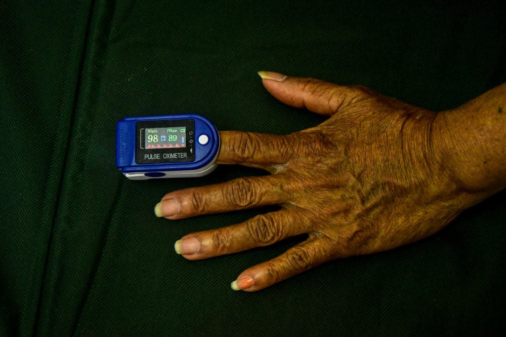 Patient’s hand with Pulse Oximeter at the free Covid-19 Clinic at Havenside Community Hall in Chatsworth on February 08, 2021 in Durban, South Africa. (Photo by Darren Stewart/Gallo Images via Getty Images)