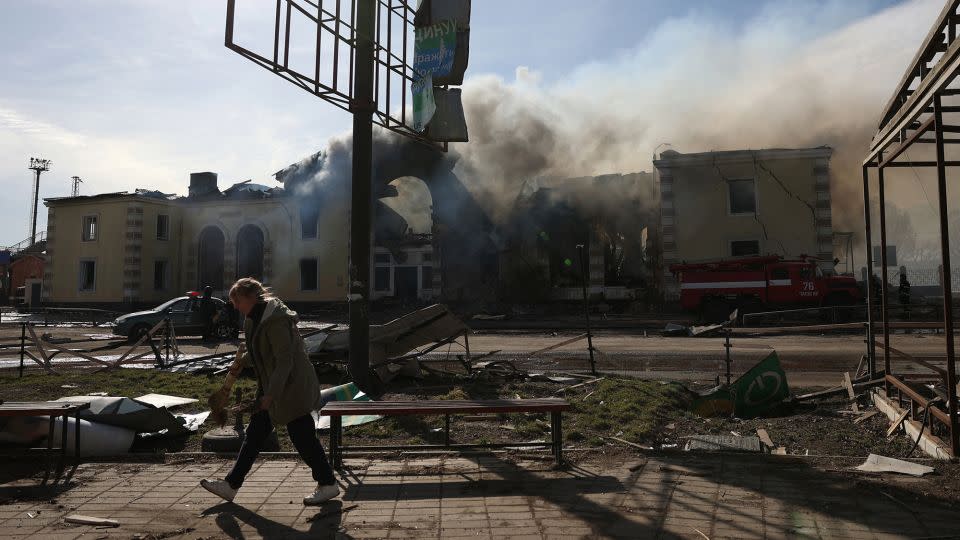 A local resident cleans debris in front of the railway station destroyed by a Russian missile attack in Kostyantynivka, Donetsk region, on February 25, 2024, amid the Russian invasion of Ukraine. - Anatolii Stepanov/AFP/Getty Images