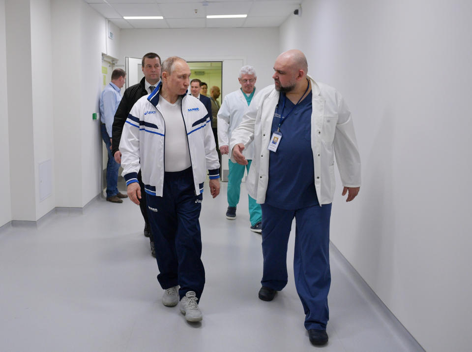 FILE - In this photo taken on March 23, 2020 , Russian President Vladimir Putin, left, and the hospital's chief Denis Protsenko, right, walk in to the hospital for coronavirus patients in Kommunarka settlement, outside Moscow, Russia. From the U.S. president to the British prime minister's top aide and far beyond, leading officials around the world are refusing to wear masks or breaking confinement rules meant to protect their populations from the coronavirus and slow the pandemic. While some are punished when they're caught, or publicly repent, others shrug off the violations as if the rules don't apply to them. (Alexei Druzhinin, Sputnik, Kremlin Pool Photo via AP, File)