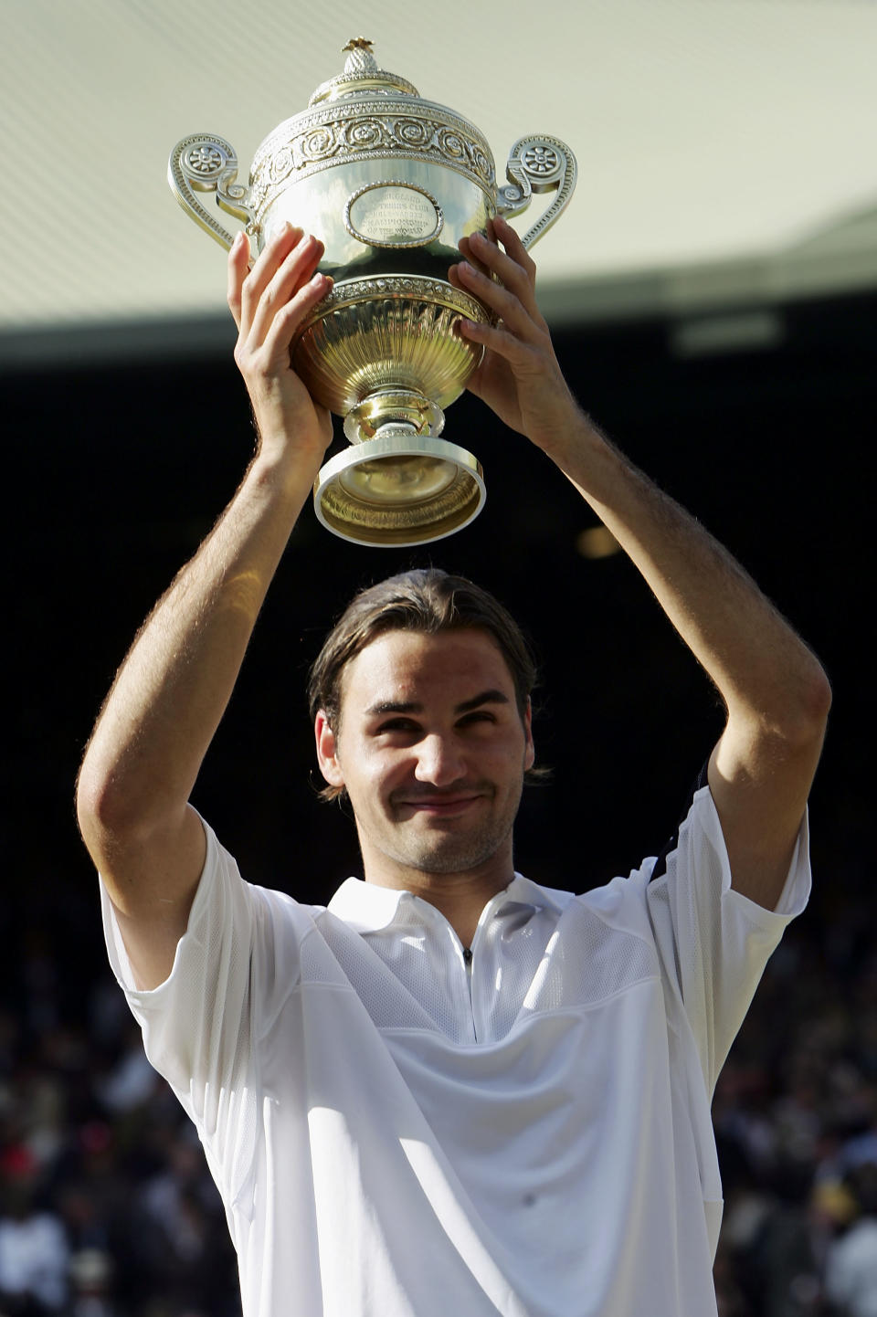 <p>Federer of Switzerland lifts his trophy after his victory against Andy Roddick of USA </p>