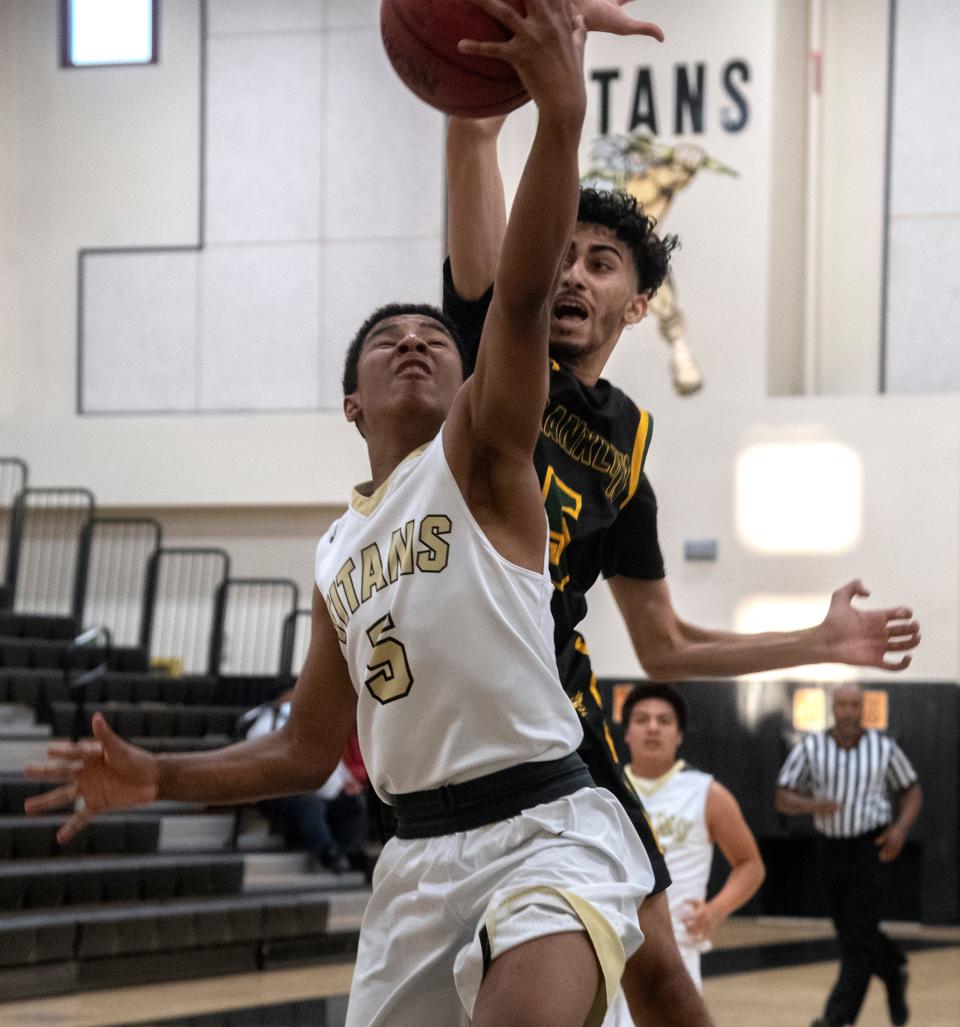 (5/7/21) Chavez's Terrell Tek, left, goes to the hoop against Franklin's Arbaaz Khan during a boys varsity basketball game at Cesar Chavez High School in Stockton. CLIFFORD OTO/THE STOCKTON RECORD