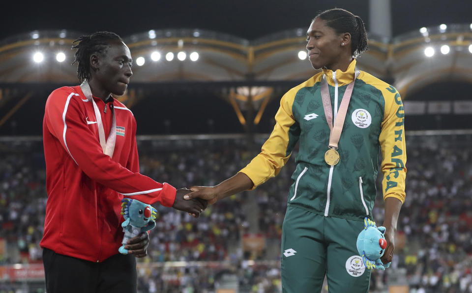 FILE - In this Friday, April 13, 2018 file photo, Women's 800m silver medal winner Kenya's Margaret Nyairera Wambui, left, shakes hands with gold medla winner South Africa's Caster Semenya on the podium at Carrara Stadium during the 2018 Commonwealth Games on the Gold Coast, Australia. Margaret Nyairera Wambui has criticized the IAAF’s testosterone regulations and is refusing to take hormone-reducing medication. (AP Photo/Mark Schiefelbein, File)