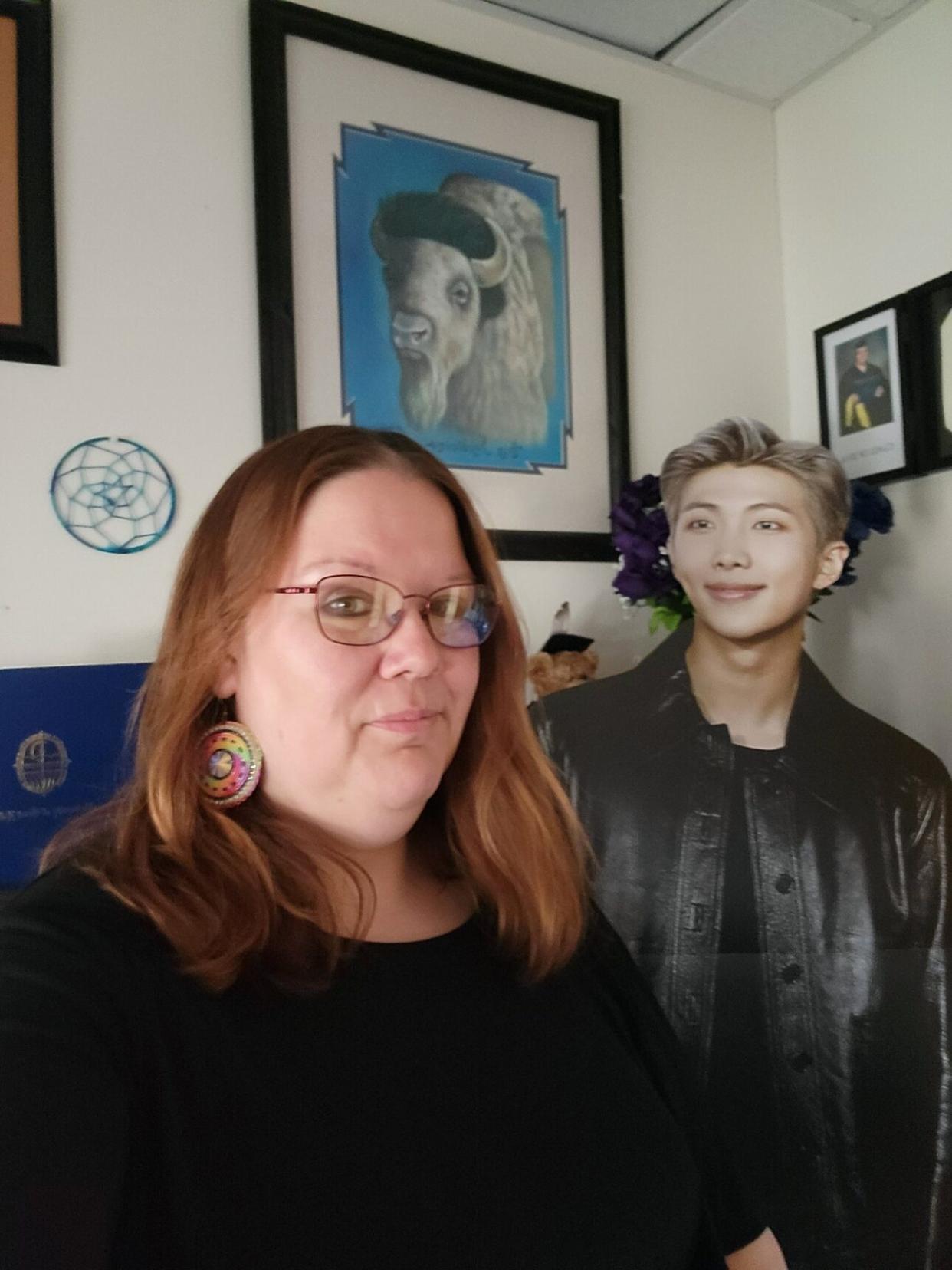 Joy Bridwell with her lifestyle cutout of BTS’s RM. (Credit: Courtesy of Joy Bridwell’s private collection.)