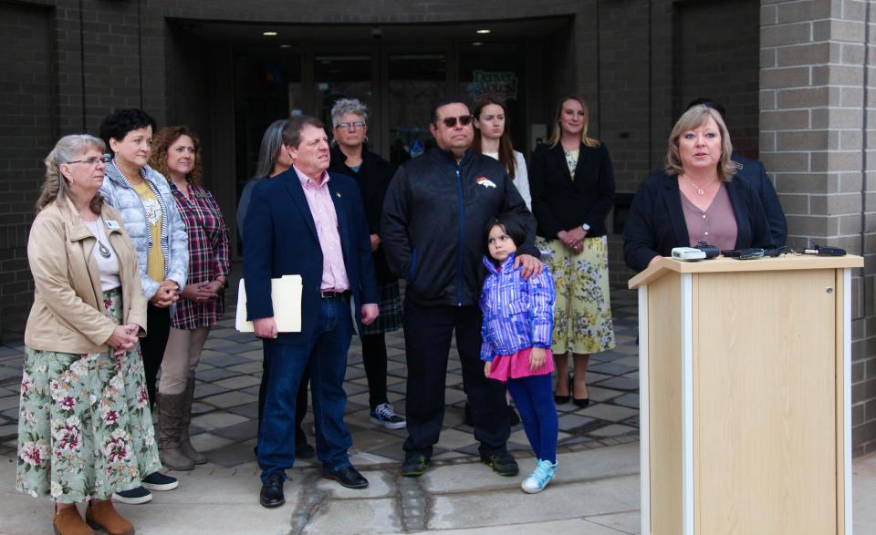 Pueblo County Clerk and Recorder Gilbert “Bo” Ortiz, fourth from right, and other Colorado county clerks listen as La Plata Clerk Tiffany Lee speaks at a rally in Denver on Sunday, April 3, 2022.