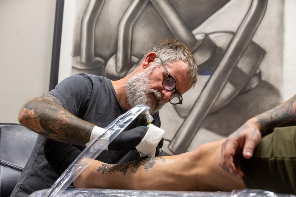 Dave Shoemaker, tattooist and owner of Ninth Wave Tattoo, works on a custom tattoo for Jonathan Quinones-Verace of Farmingdale as he talks about his business in Asbury Park, NJ Thursday, October 20, 2022. 