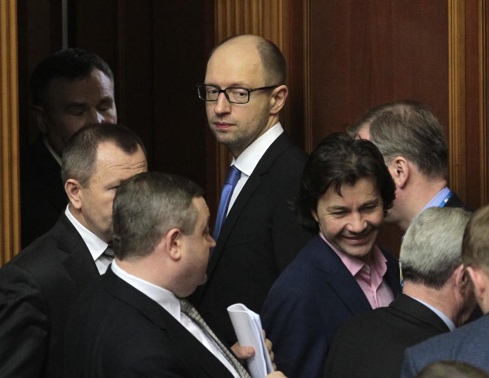 Ukrainian Prime Minister Arseniy Yatsenyuk,center, looks on during a session at the Ukrainian parliament in Kiev, Ukraine, Thursday, March. 27, 2014. (AP Photo/Sergei Chuzavkov)