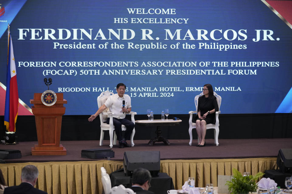 Philippine President Ferdinand Marcos Jr., left, answers questions beside Foreign Correspondents Association of the Philippines president Girlie Linao during a forum on Monday, April 15, 2024, in Manila, Philippines. (AP Photo/Aaron Favila)