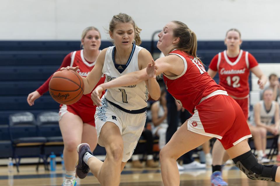 Rootstown’s Colbie Curall drives through Crestwood’s Abby Guyette to the basket during a basketball game Tuesday, Nov. 28 in Rootstown.