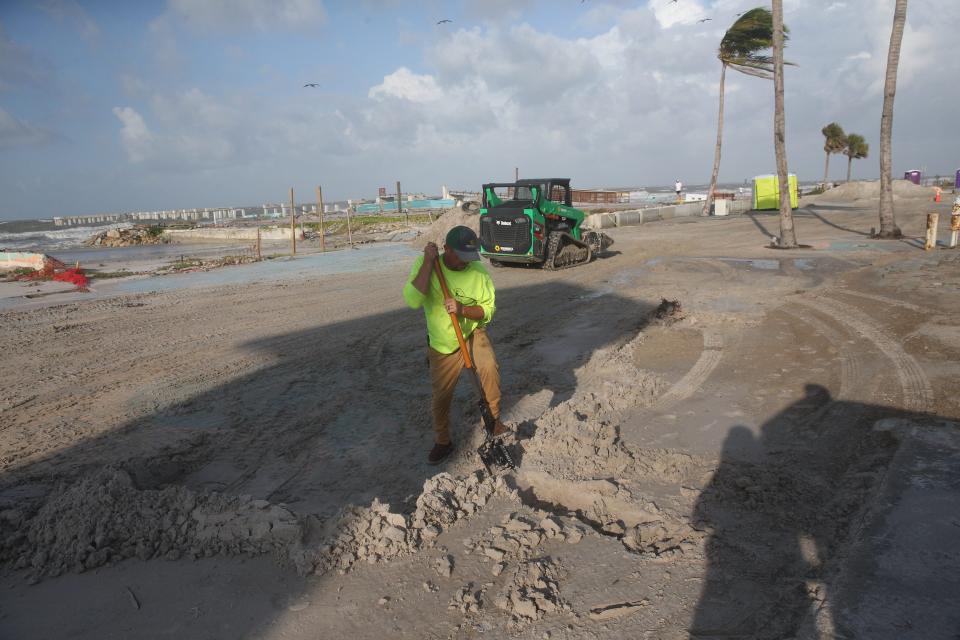 Employees for the Fort Myers Beach Town Public Works clean up Times Square after storm surge from Hurricane Idalia washed on shore on Wednesday, Aug. 30 2023. The island sustained minimal storm surge flooding.