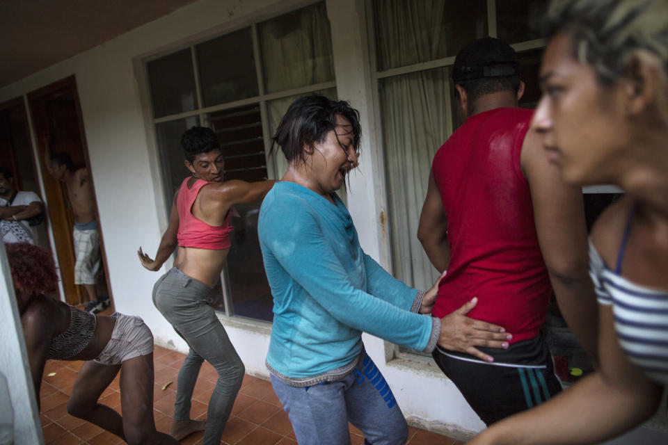 In this Nov. 1, 2018 photo, members of the LGBTQ community who are part of the Central American migrants caravan hoping to reach the U.S. border, break into a celebratory dance outside an abandoned hotel after arriving in Donaji, Mexico. The 50 or so LGBTQ migrants traveling together, most of them in their 20s but some as young as 17 or as old as 60, say they banded together for safety in numbers, a sort of caravan within the caravan. (AP Photo/Rodrigo Abd)
