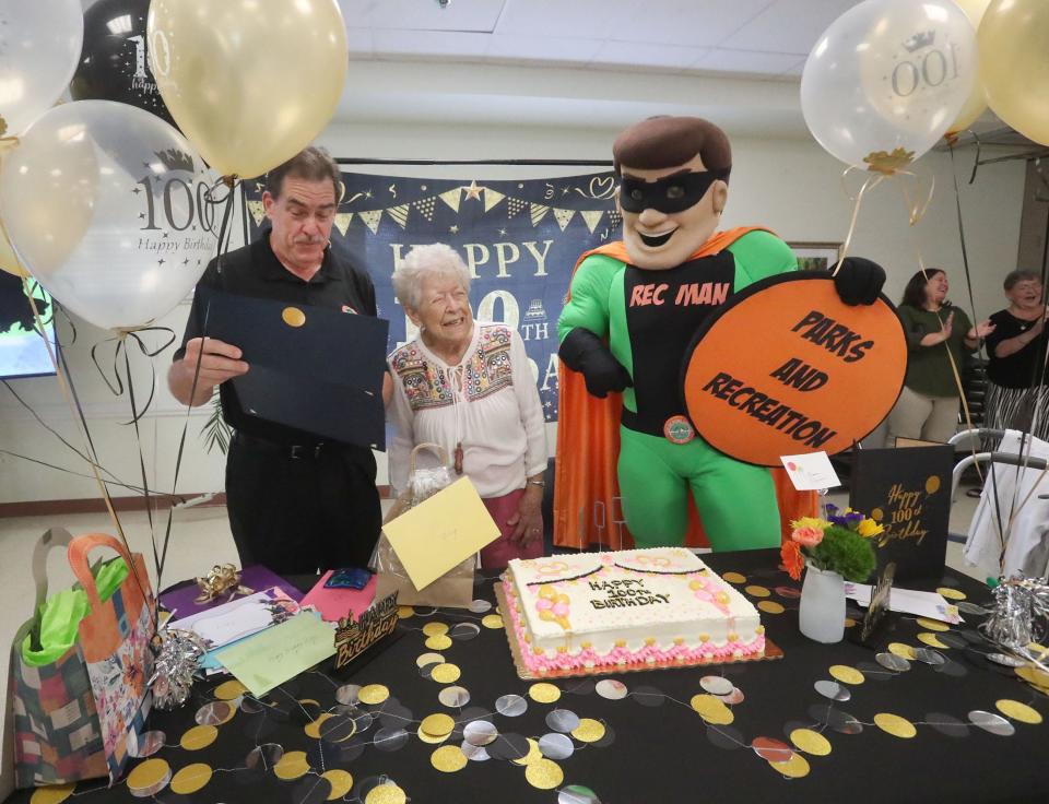 Elizabeth Parisi reacts as Port Orange Mayor Don Burnette reads a proclamation naming her Port Orange Queen for the Day in celegration of her 100th birthday, Wednesday October 11, 2023 during a celebration at the Adult Activity Center.