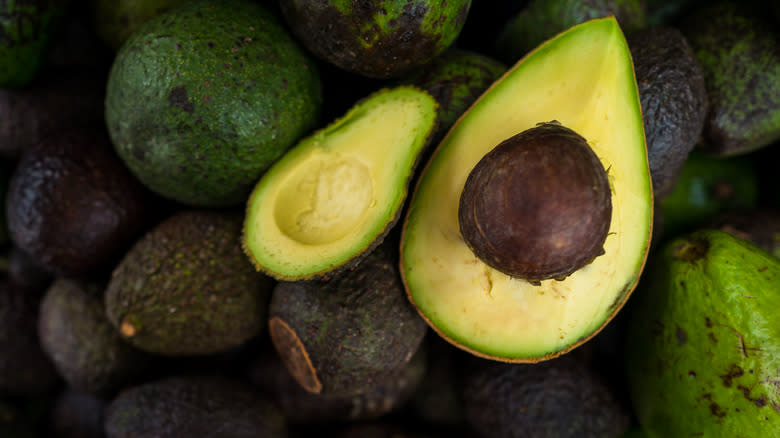 Halved avocado with pit