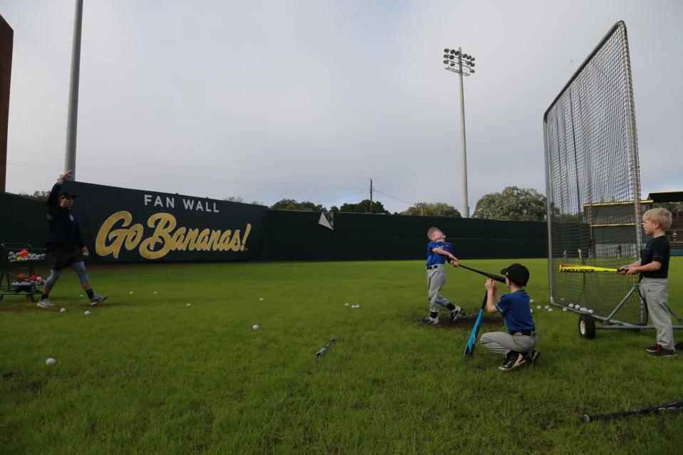 Instructor Brian Eichhorn, a pitcher in the Cleveland farm system, throws to a group of young campers at the home-run derby station on Tuesday during the Savannah Bananas winter baseball camp at Grayson Stadium.