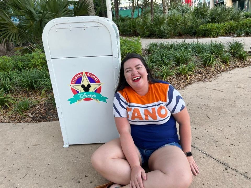 megan posing with a trash can at the all star movies resort in disney world