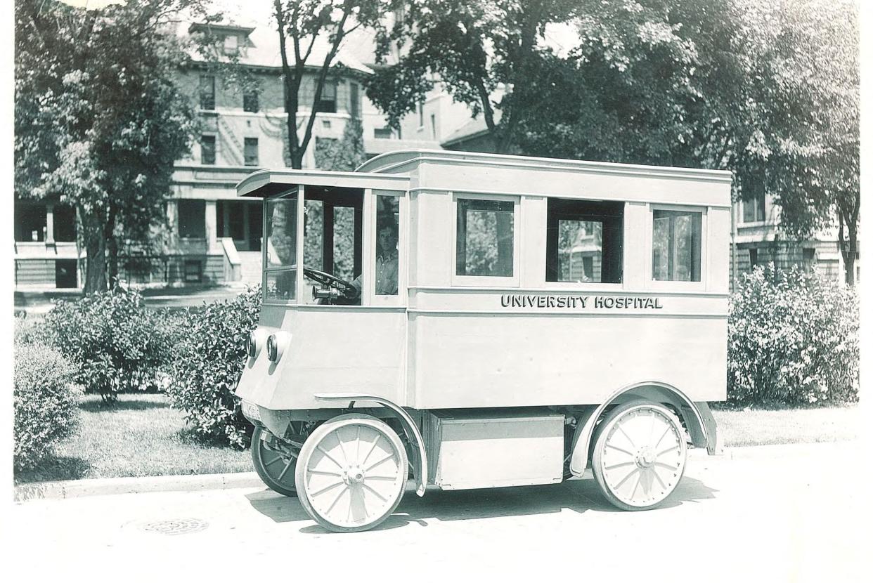 In 1920, this battery-powered University of Iowa hospital bus was photographed on Iowa Avenue, across from the 1897 hospital.