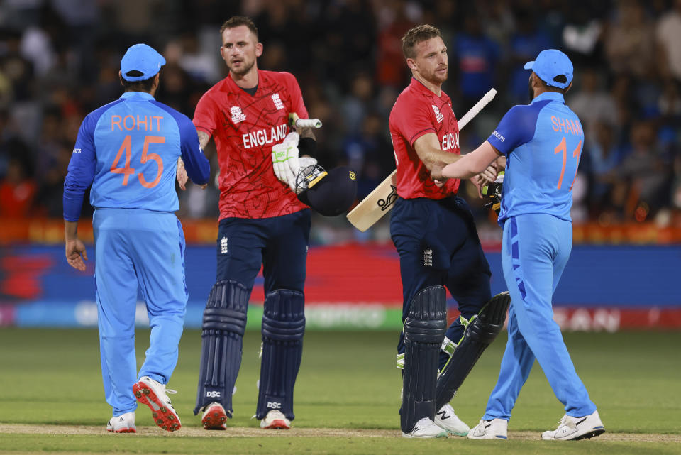 India's Mohammed Shami, right, shakes hands with England captain Jos Butler as India's captain Rohit Sharma, left, congratulates Alex Hales after the T20 World Cup cricket semifinal between England and India in Adelaide, Australia, Thursday, Nov. 10, 2022. England defeated India by ten wickets. (AP Photo/James Elsby)