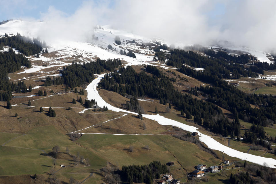 FILE - A strip of snow makes a ski slope in Saalbach, Austria, Sunday, March 17, 2024. The U.N. weather agency is sounding “a red alert” about global warming last year and beyond, citing in a new report record-smashing statistics when it comes to greenhouse gases, temperatures of land and oceans, and melting glaciers and sea-ice — even if countries, companies and citizens are getting greener. (AP Photo/Alessandro Trovati, File)