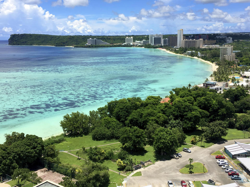 FILE -- This Aug. 14, 2017 file photo shows Tumon Bay near Hagåtña, Guam. The 1941 Japanese invasion of Guam, which happened on the same December day as the attack on Hawaii's Pearl Harbor, set off years of forced labor, internment, torture, rape and beheadings. Now, more than 75 years later, thousands of people on Guam, a U.S. territory, are expecting to get long-awaited compensation for their suffering at the hands of imperial Japan during World War II. (AP Photo/Tassanee Vejpongsa, File)