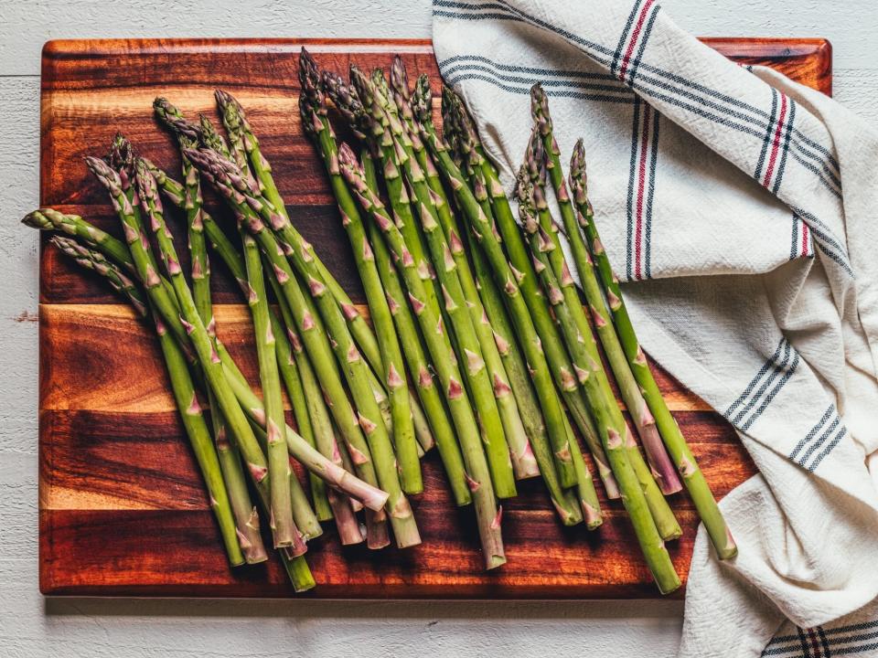 various asparagus spears on a cutting board