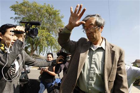 A man widely believed to be Bitcoin currency founder Satoshi Nakamoto is surrounded by reporters as he leaves his home in Temple City, California March 6, 2014. REUTERS/David McNew