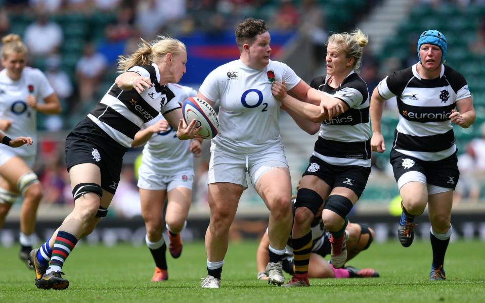 Hannah Botterman of England makes a break past Tamara Taylor and Claire Molloy of Barbarians during the England Women v Barbarian Women match at Twickenham - GETTY IMAGES