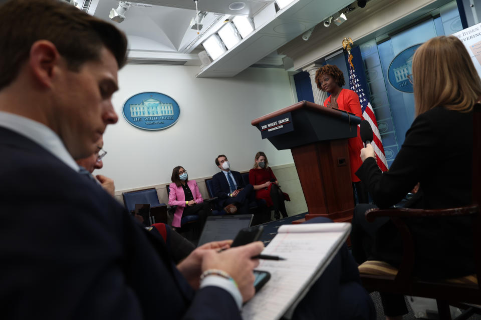 With reporters in the foreground, White House press secretary Karine Jean-Pierre speaks at a briefing.
