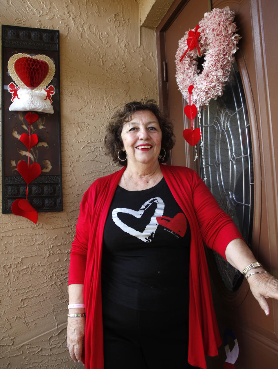 In this Wednesday, Feb. 29, 2012 photo, Carol McKenna, 70, is shown at her home in Pembroke Pines, Fla. As the U.S. Supreme Court prepares to hear arguments on President Barack Obama's health care overhaul, The Associated Press spoke with a variety of people to hear their experiences so far with the landmark legislation, whose major provisions don’t take effect until 2014. Reporters asked: How has the health care law affected your life? McKenna and her husband Morty have noticed that Medicare’s “doughnut hole” is shrinking. The coverage gap in Medicare's prescription drug program, dubbed the “doughnut hole,” caught Morty in December last year. But once there, he received a 50 percent discount on brand-name drugs and other discounts on generic drugs thanks to Obama’s health care law. (AP Photo/Wilfredo Lee)