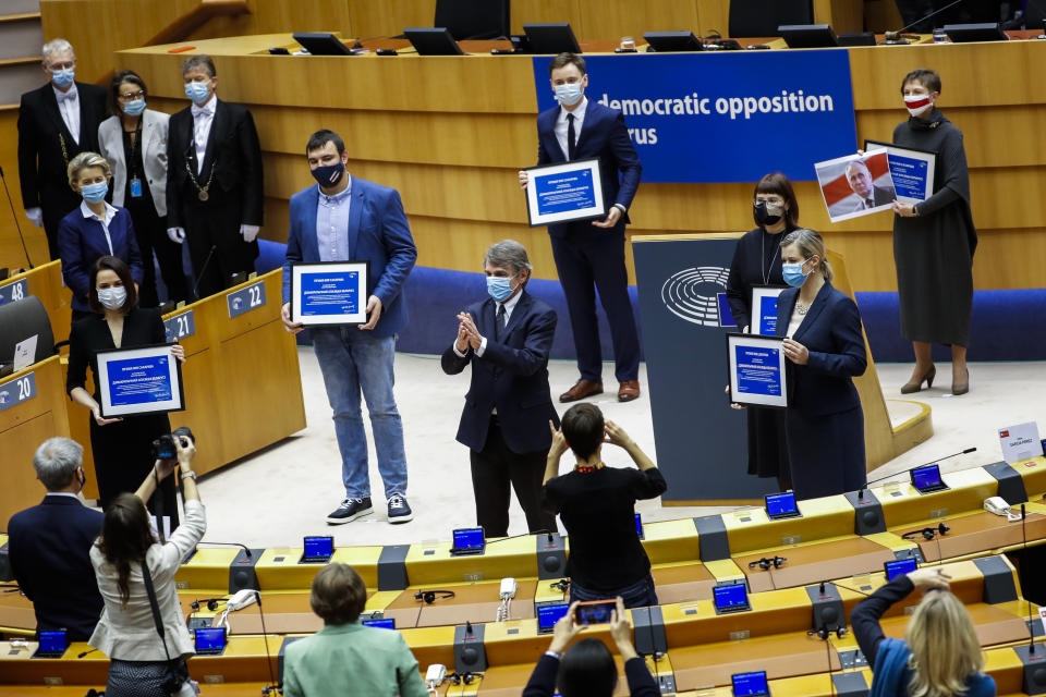 Belarusian opposition politicians are applauded as they hold their prizes during the Sakharov Prize ceremony at the European Parliament in Brussels, Wednesday, Dec. 16, 2020. The European Union has awarded its top human rights prize to the Belarusian democratic opposition. (AP Photo/Francisco Seco)