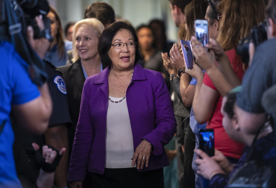 Sen. Mazie Hirono, D-Hawaii, with Sen. Kirsten Gillibrand, D-N.Y., left, is applauded by demonstrators as the arrive to speak to reporters in support of professor Christine Blasey Ford, who is accusing Supreme Court nominee Brett Kavanaugh of a decades-old sexual attack, during a news conference on Capitol Hill in Washington, Thursday, Sept. 20, 2018. (AP Photo/J. Scott Applewhite)