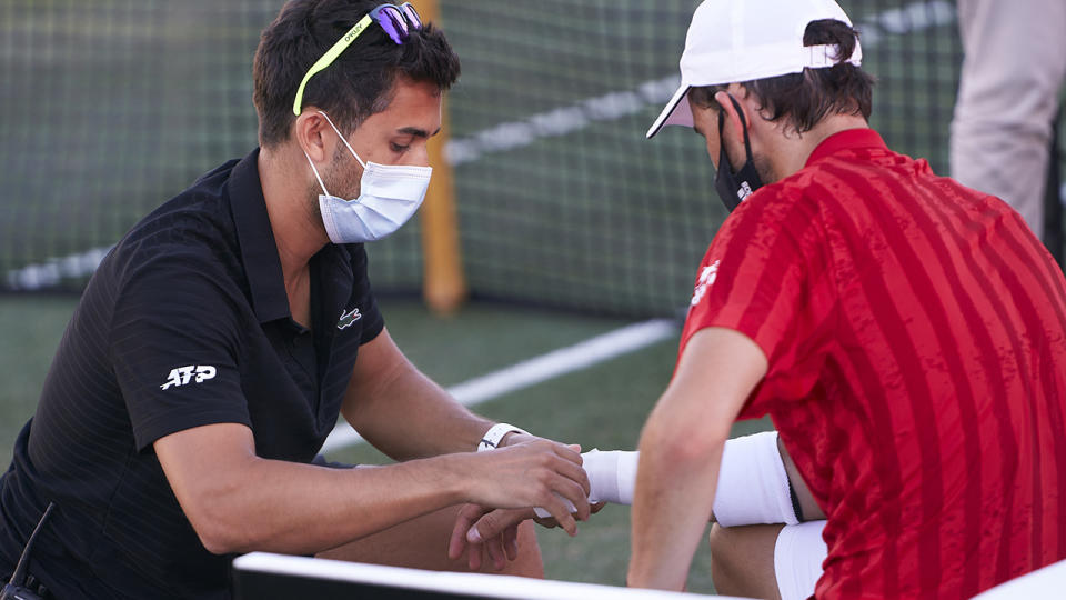 Dominic Thiem, pictured here receiving medical treatment during the Mallorca Championships in June.