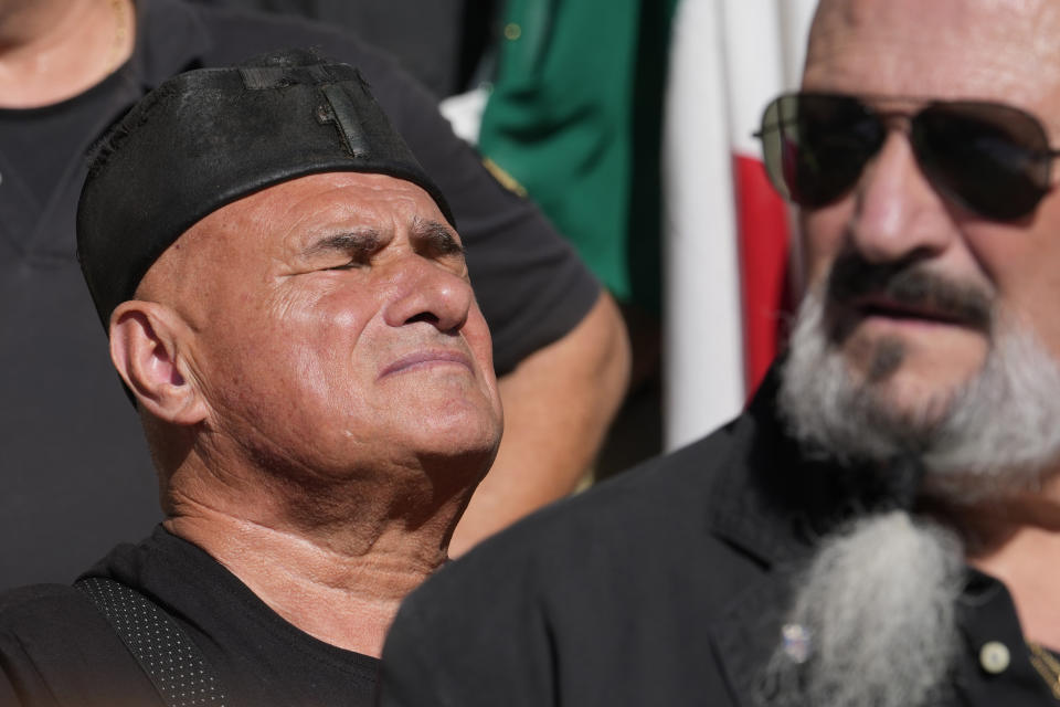 People march in the hometown of former dictator Benito Mussolini to mark the 100th anniversary of the coup d'etat by which he sized power in 1922, in Predappio, Italy, Sunday, Oct. 30, 2022. (AP Photo/Luca Bruno)